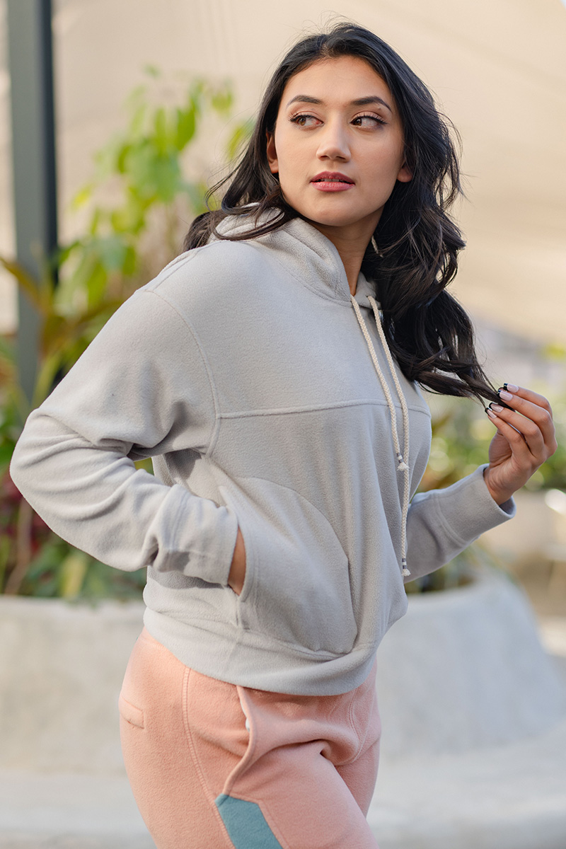 A stylish and warm women's hoodie made of light polar fleece and polyester material, perfect for online purchase and delivery.